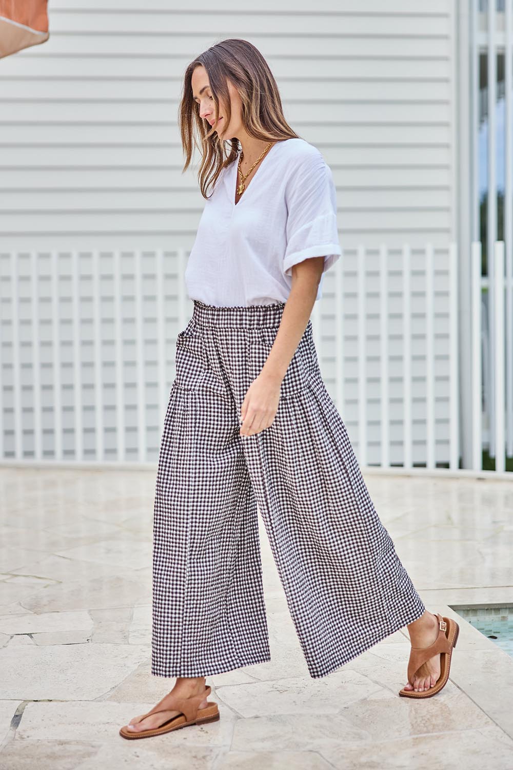 Model Tegand wearing size 10 of the Break Of Day Cotton Pants - Choccheck in colour Choccheck, from the front