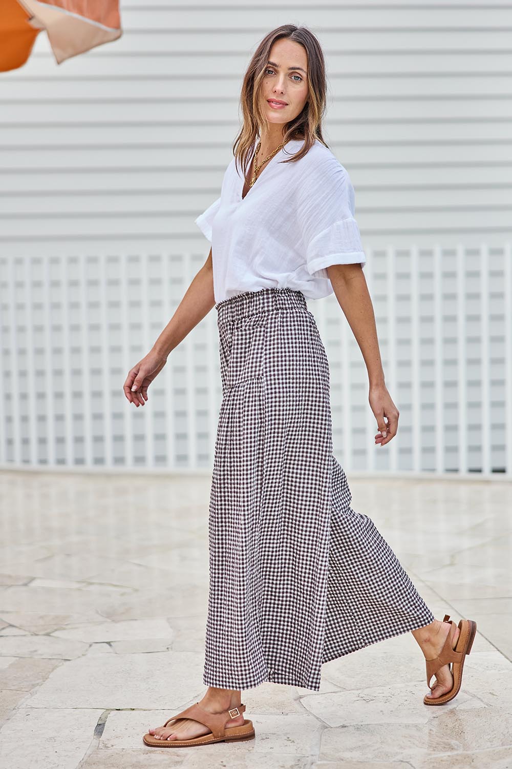 Model Tegand wearing size 10 of the Break Of Day Cotton Pants - Choccheck in colour Choccheck, from the front