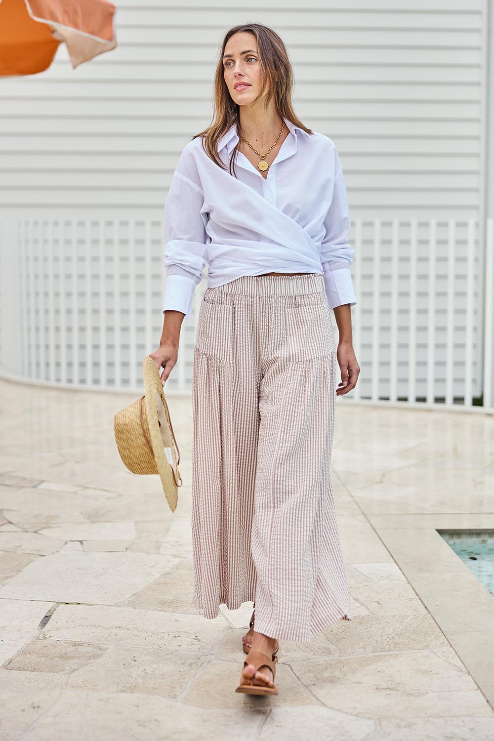 Model Tegand wearing size 10 of the Break Of Day Cotton Pants - Sandstripe in colour Sandstripe, from the front