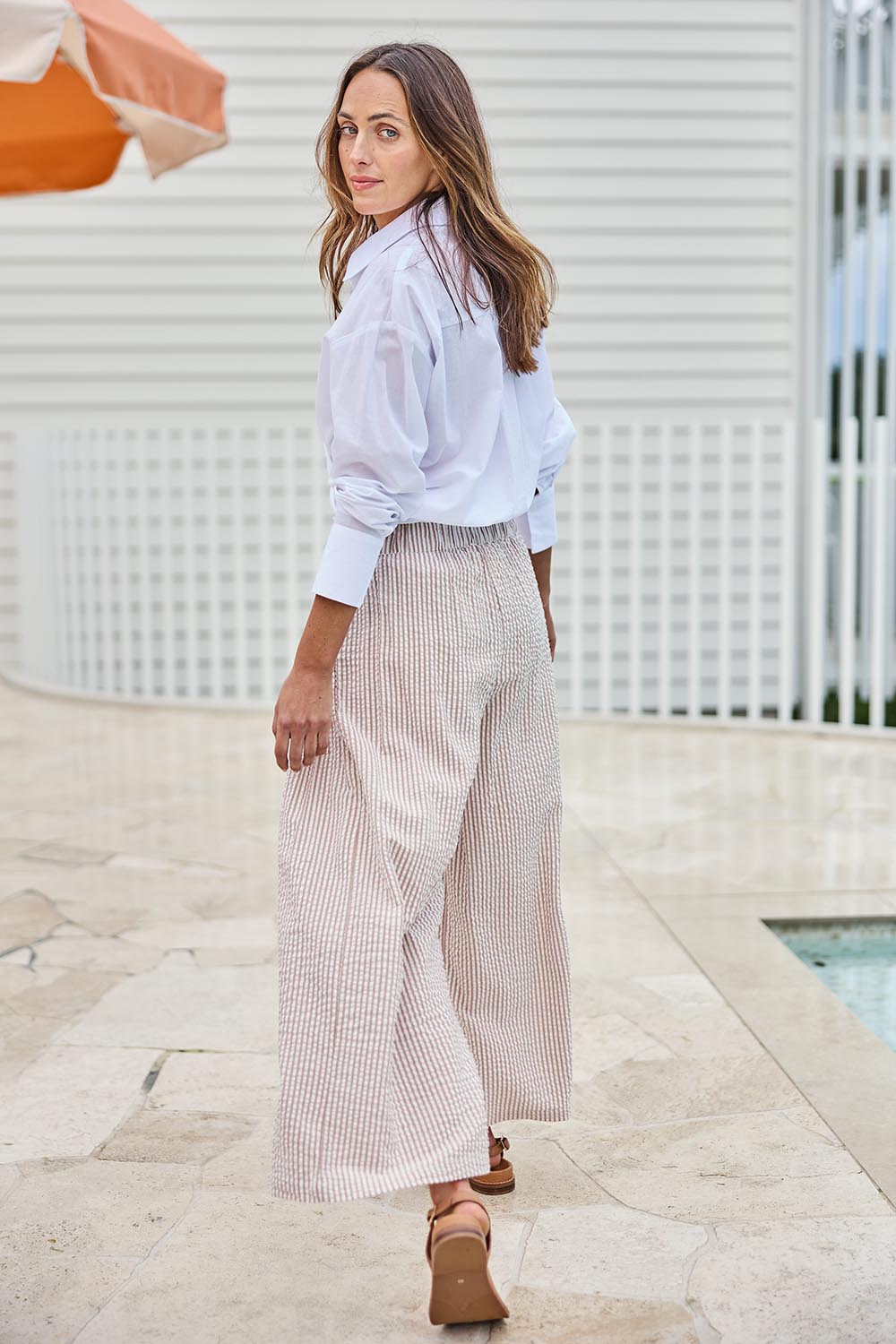 Model Tegand wearing size 10 of the Break Of Day Cotton Pants - Sandstripe in colour Sandstripe, from the front