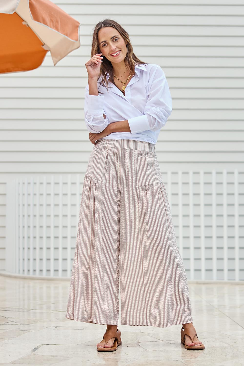 Model Tegand wearing size 10 of the Break Of Day Cotton Pants - Sandstripe in colour Sandstripe, from the front