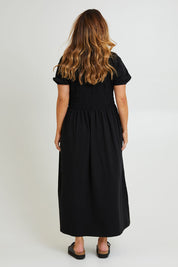 Model Laura wearing size 14 of the Casual Friday Dress in colour Black (Black), from the back