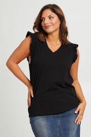 Model Monique wearing size 14 of the For The Frill Of It Tee in colour Black (Black), from the front, cropped image