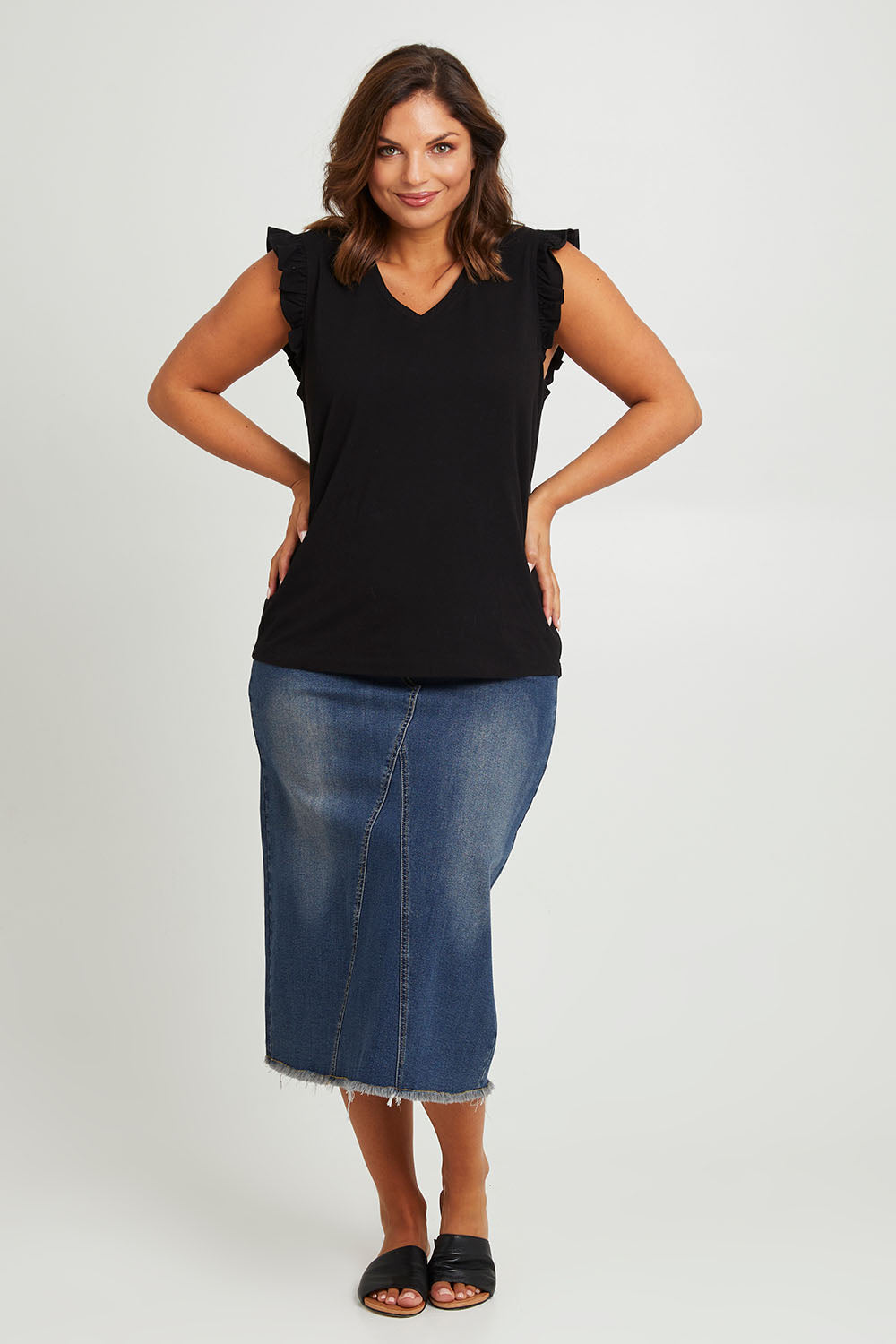 Model Monique wearing size 14 of the For The Frill Of It Tee in colour Black (Black), from the front, showing the whole outfit