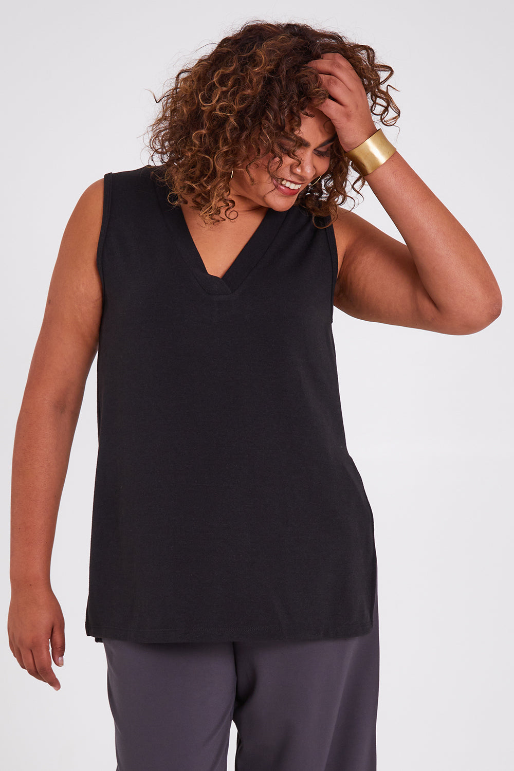 Model Anucia wearing size 14 of the Snuggle Up Vest in colour Black (Black), from the front, cropped image