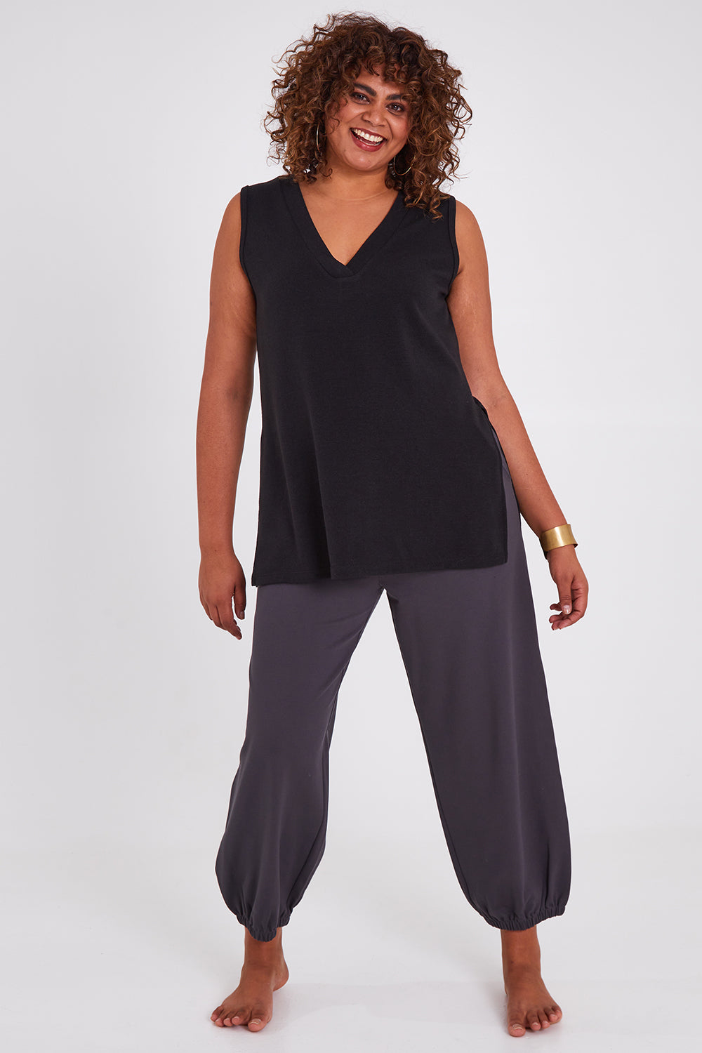 Model Anucia wearing size 14 of the Snuggle Up Vest in colour Black (Black), from the front, showing the whole outfit