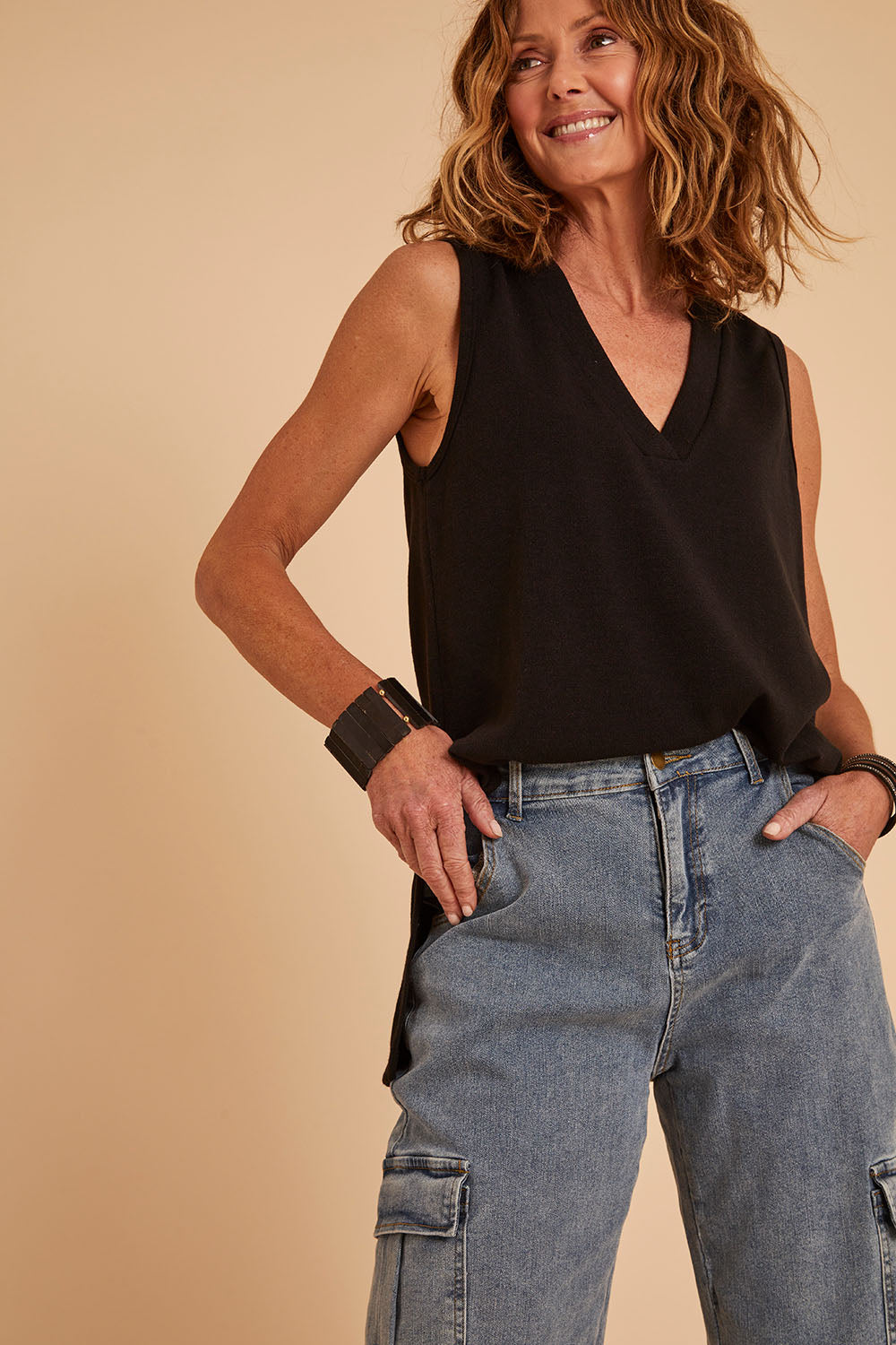 Model Emma wearing size 10 of the Snuggle Up Vest in colour Black (Black), from the front, cropped image