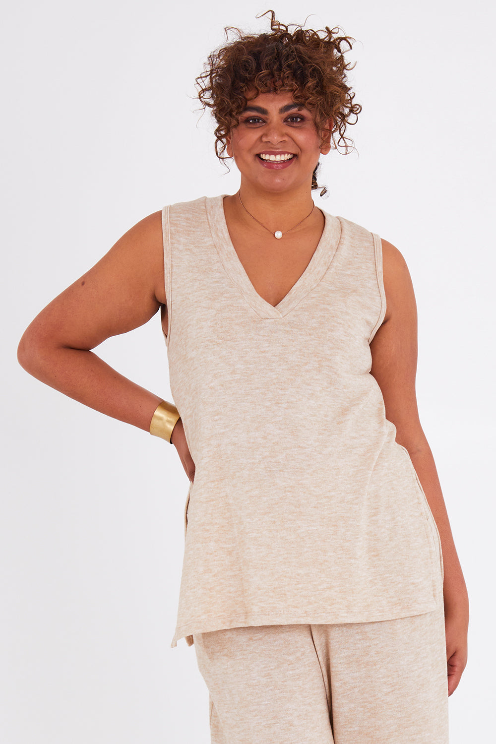 Model Anucia wearing size 14 of the Snuggle Up Vest in colour Sand, from the front, cropped image