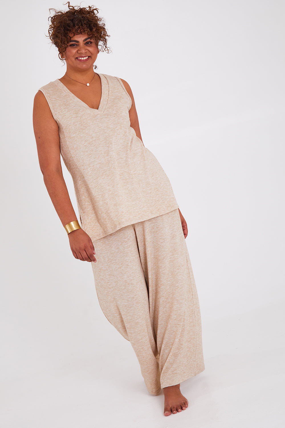 Model Anucia wearing size 14 of the Snuggle Up Vest in colour Sand, from the front, showing the whole outfit