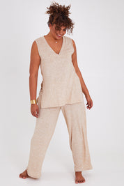 Model Anucia wearing size 14 of the Snuggle Up Vest in colour Sand, from the front, showing the whole outfit