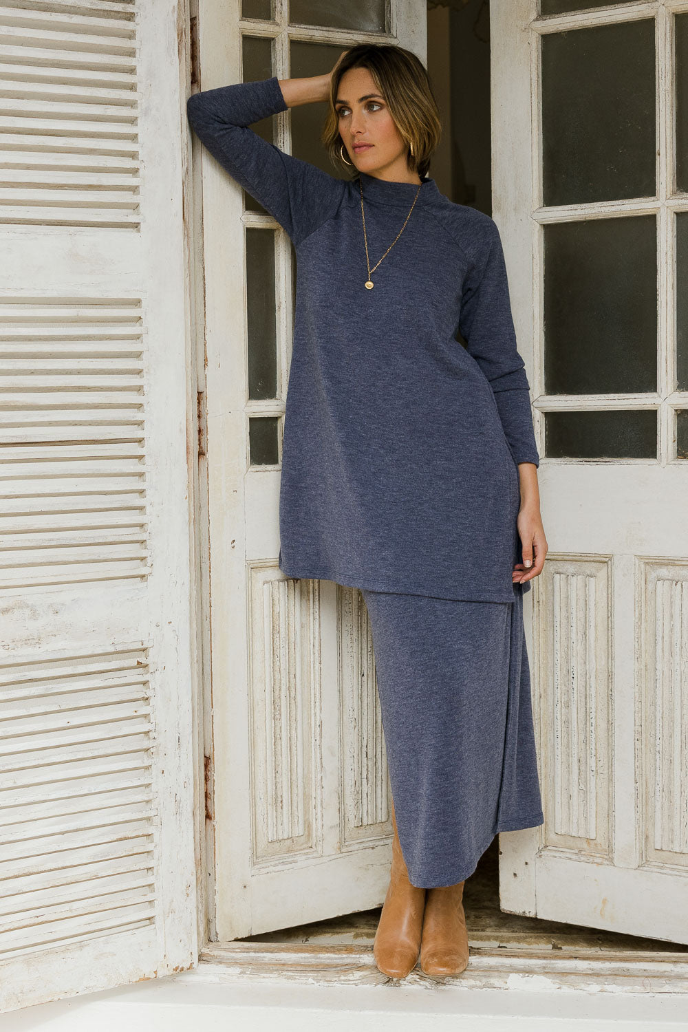 Model Tegan wearing size 10 of the Snuggle Up Tunic Top in colour Marldenim (Blue), from the front, showing the whole outfit
