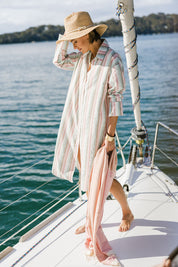 Model Tegan wearing size 10 of the Happy Times Tunic Shirt in colour Stripe (Blue), from the front, showing the whole outfit
