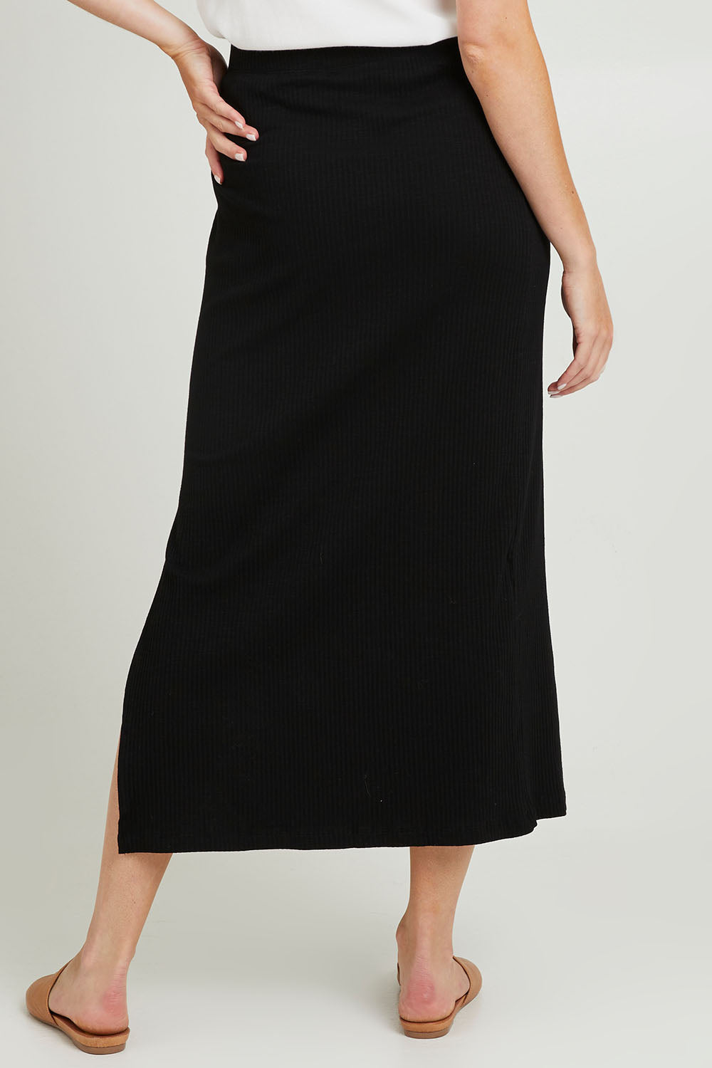 Model Grace wearing size 10 of the Coffee Run Skirt Set in colour Black (Black), from the back