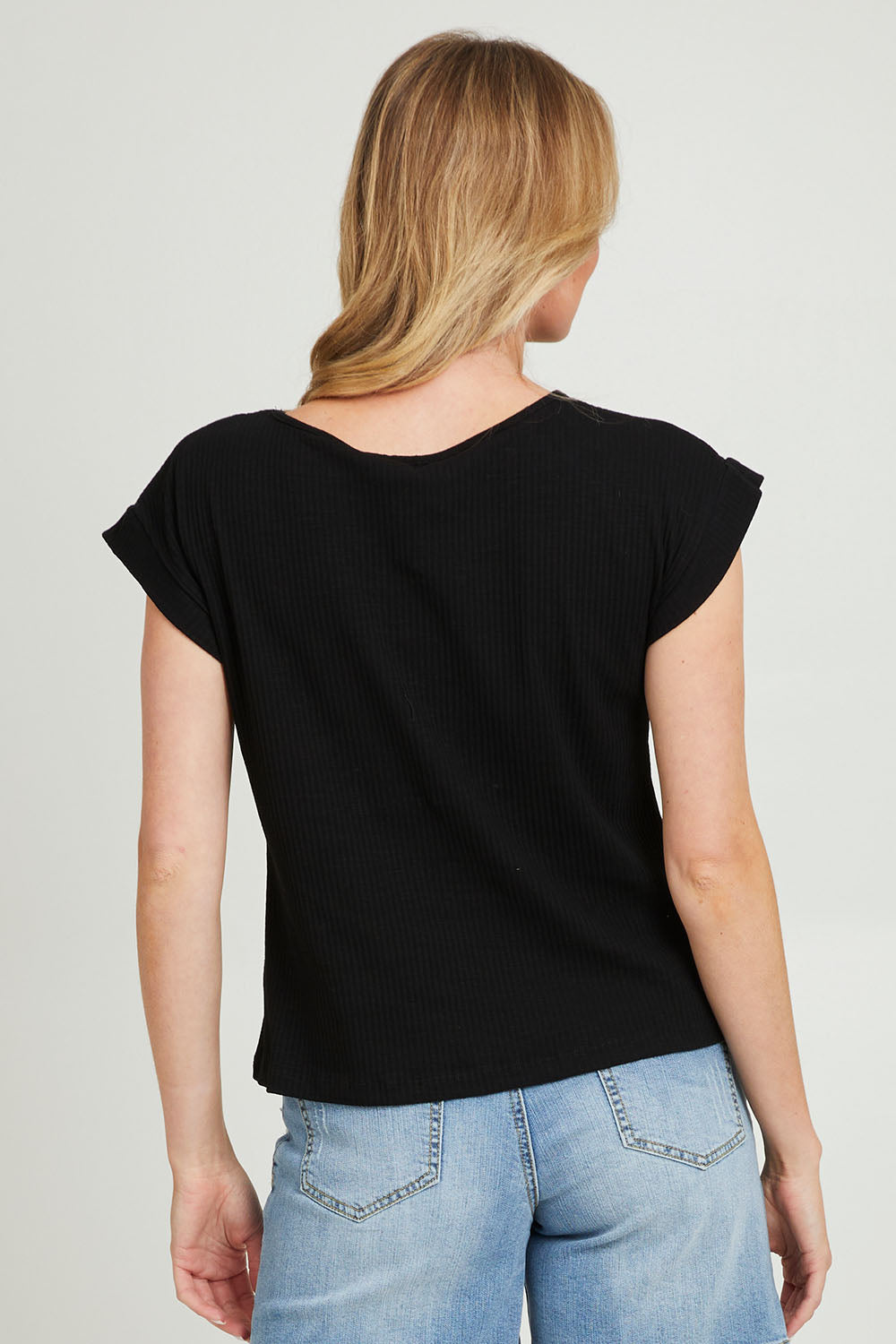 Model Grace wearing size 10 of the Coffee Run Skirt Set in colour Black (Black), from the back