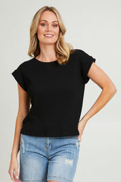 Model Grace wearing size 10 of the Coffee Run Skirt Set in colour Black (Black), from the front, cropped image