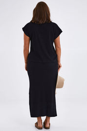 Model Monique wearing size 14 of the Coffee Run Skirt Set in colour Black (Black), from the back