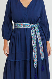 Model Laura wearing size M-L of the Finishing Touch Embroidered Belt in colour Bluefleur (Blue), from the front, cropped image