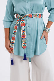 Model Monique wearing size M-L of the Finishing Touch Embroidered Belt in colour Bright, from the front, cropped image