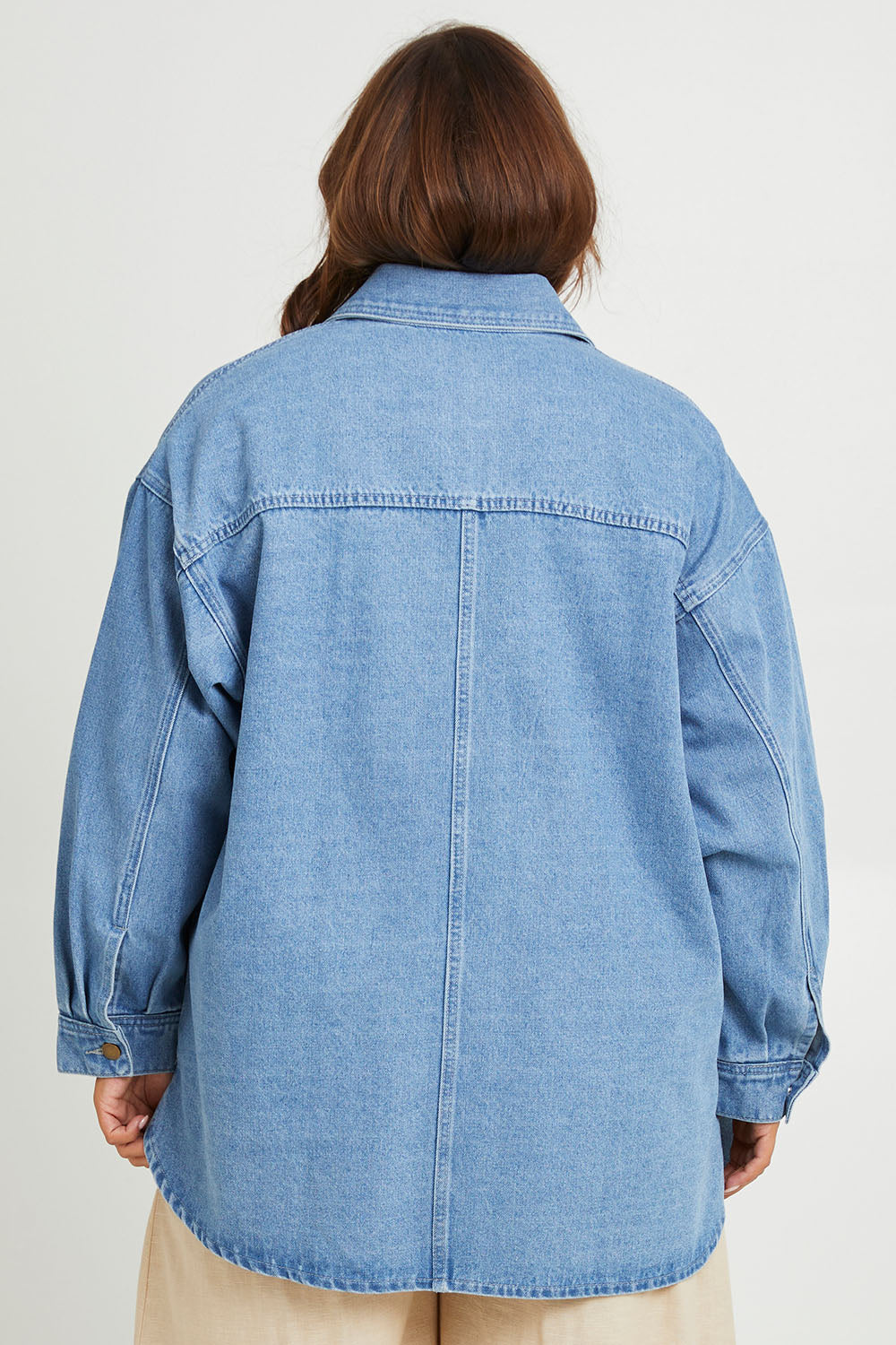 Model Monique wearing size 14 of the Good Times Oversize Denim Jacket in colour Denim (Blue), from the back