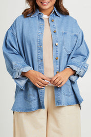 Model Monique wearing size 14 of the Good Times Oversize Denim Jacket in colour Denim (Blue), from the front, cropped image