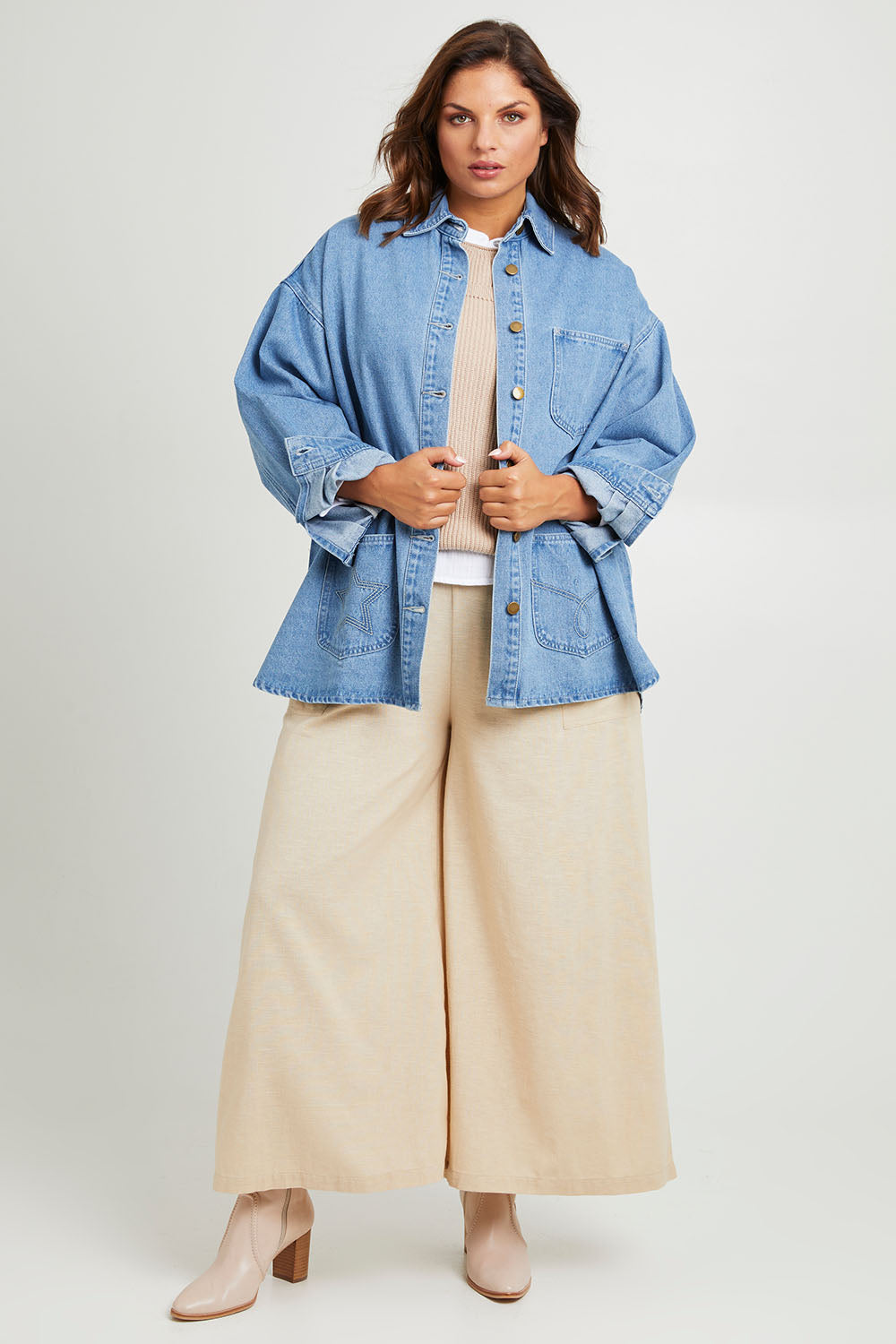 Model Monique wearing size 14 of the Good Times Oversize Denim Jacket in colour Denim (Blue), from the front, showing the whole outfit