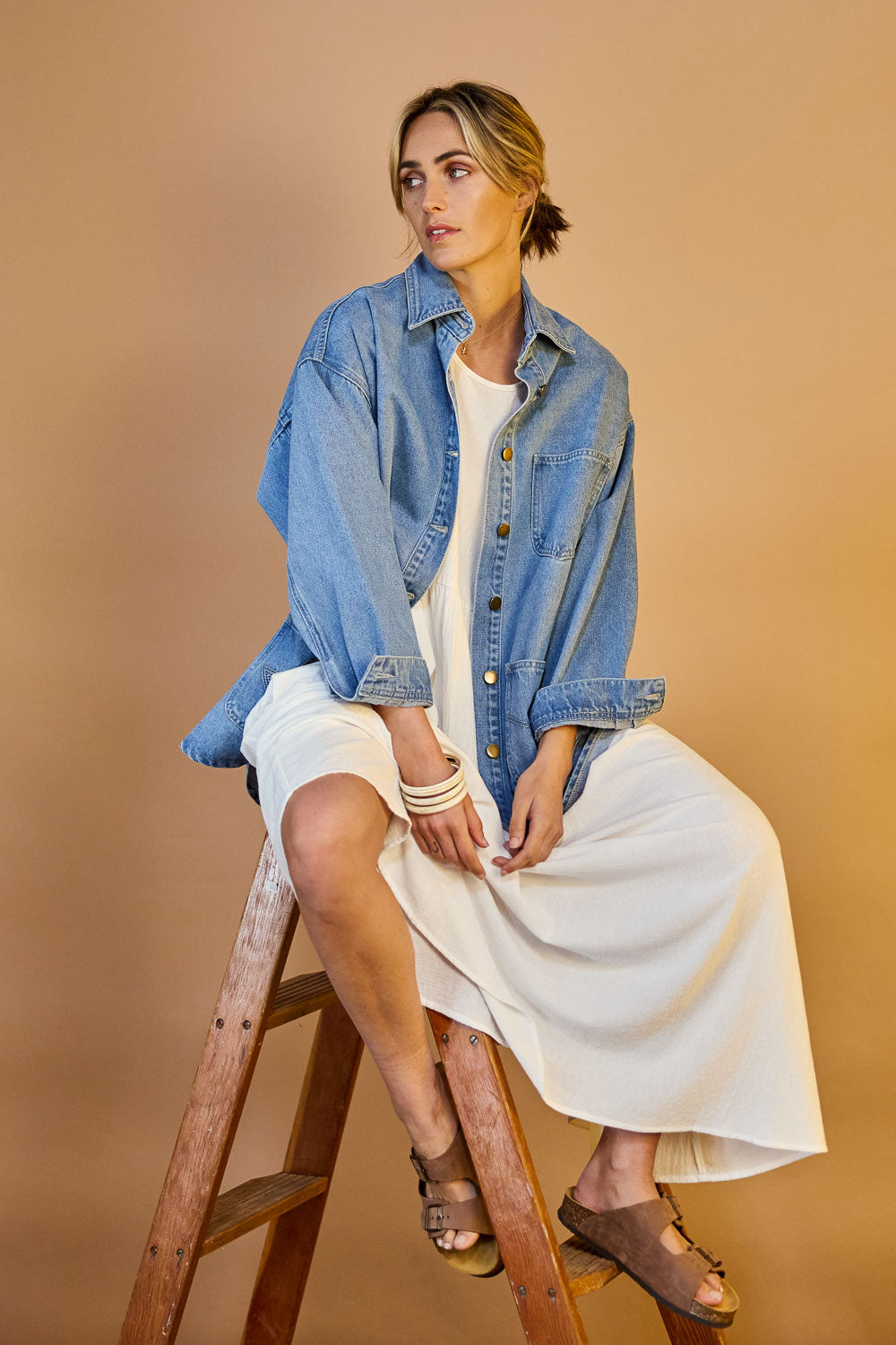 Model Tegan wearing size 10 of the Good Times Oversize Denim Jacket in colour Denim (Blue), from the front, showing the whole outfit