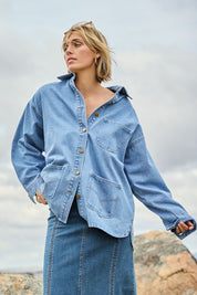Model Tegan wearing size 10 of the Good Times Oversize Denim Jacket in colour Denim (Blue), from the front, showing the whole outfit