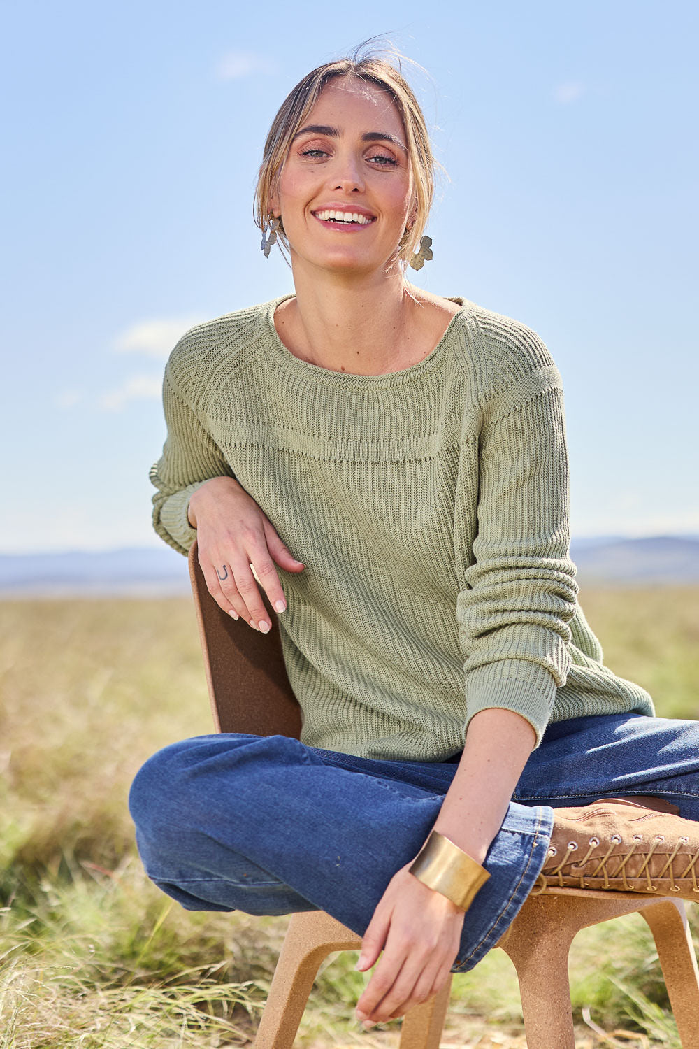 Model Tegan wearing size S of the Cover Me In Cotton Sweater in colour Sage (Green), from the front, showing the whole outfit