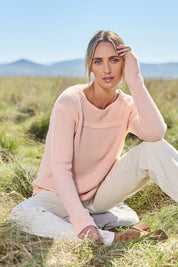 Model Tegan wearing size S of the Cover Me In Cotton Sweater in colour Sherbet (Pink), from the front, showing the whole outfit