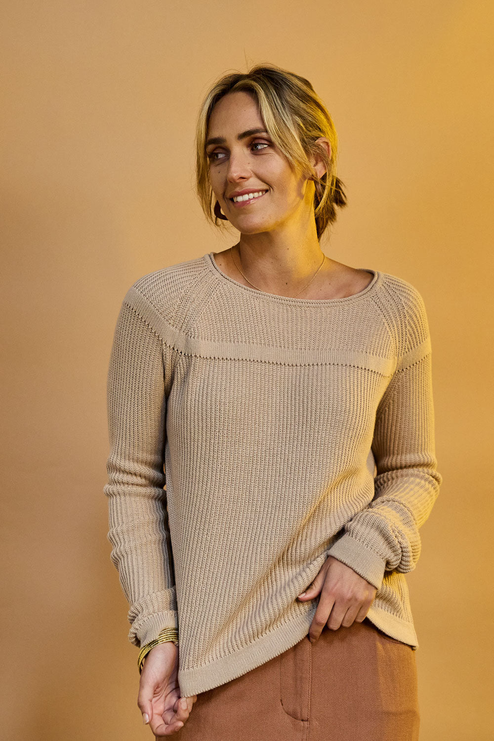 Model Tegan wearing size S of the Cover Me In Cotton Sweater in colour Stone, from the front, showing the whole outfit