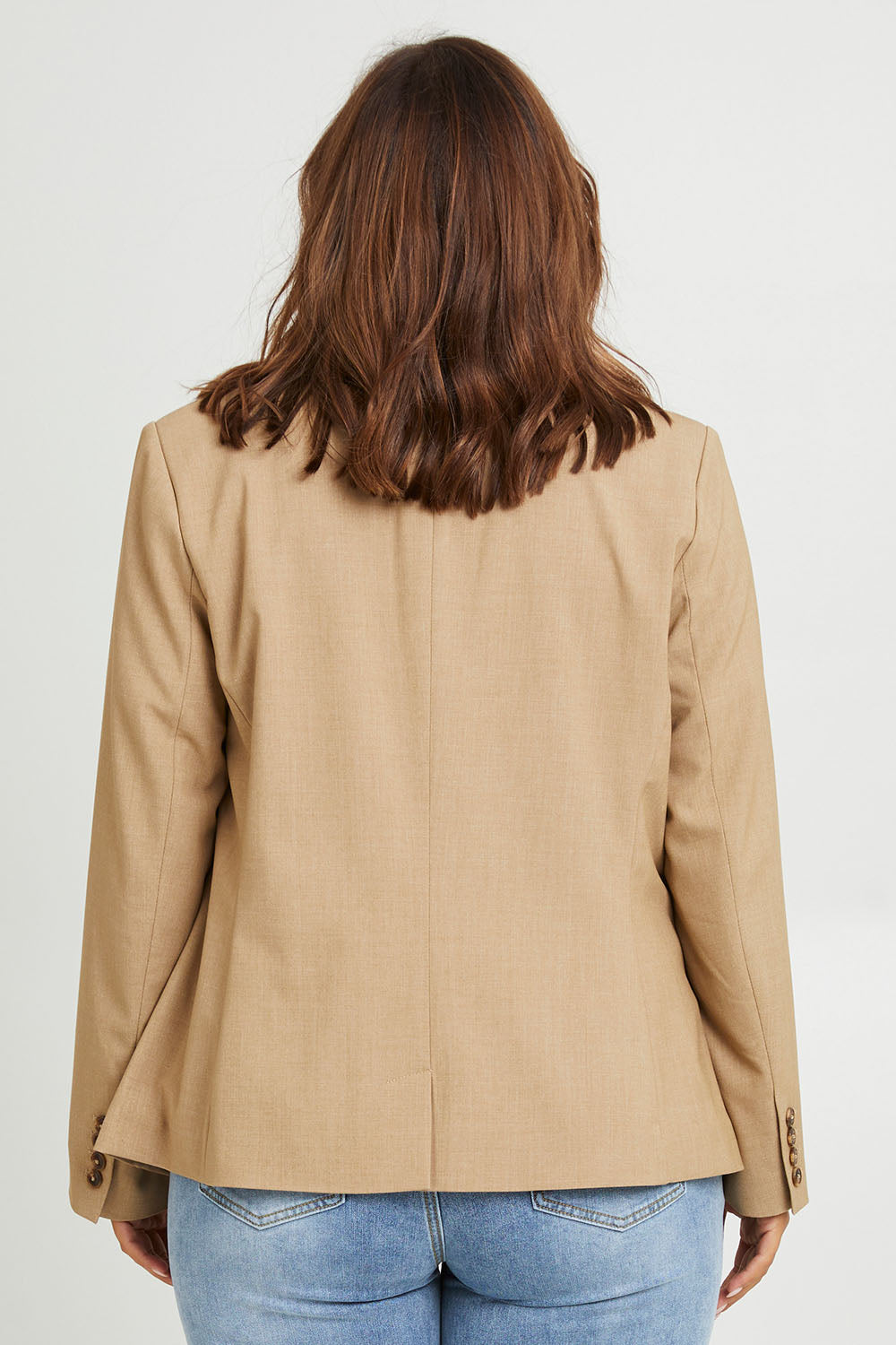 Model Monique wearing size 14 of the Sweet Whispers Blazer in colour Sand, from the back