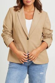 Model Monique wearing size 14 of the Sweet Whispers Blazer in colour Sand, from the front, cropped image