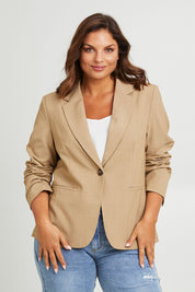 Model Monique wearing size 14 of the Sweet Whispers Blazer in colour Sand, from the front, cropped image