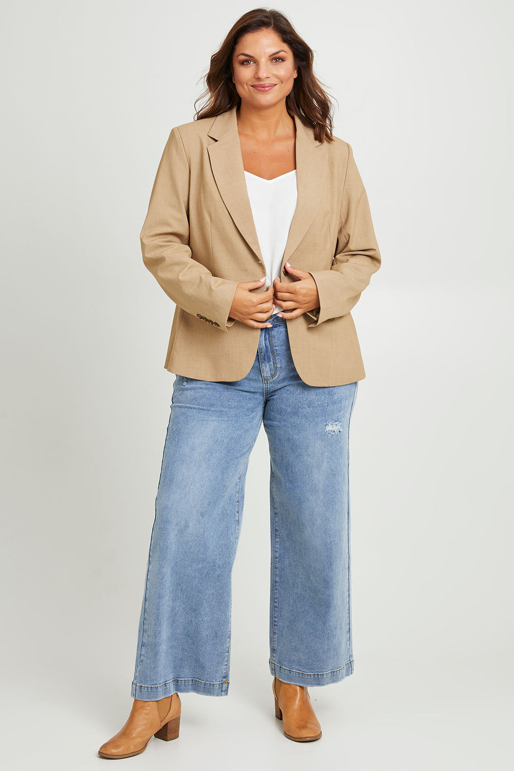 Model Monique wearing size 14 of the Sweet Whispers Blazer in colour Sand, from the front, showing the whole outfit