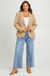Model Monique wearing size 14 of the Sweet Whispers Blazer in colour Sand, from the front, showing the whole outfit