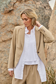 Model Tegan wearing size 10 of the Sweet Whispers Blazer in colour Sand, from the front, showing the whole outfit