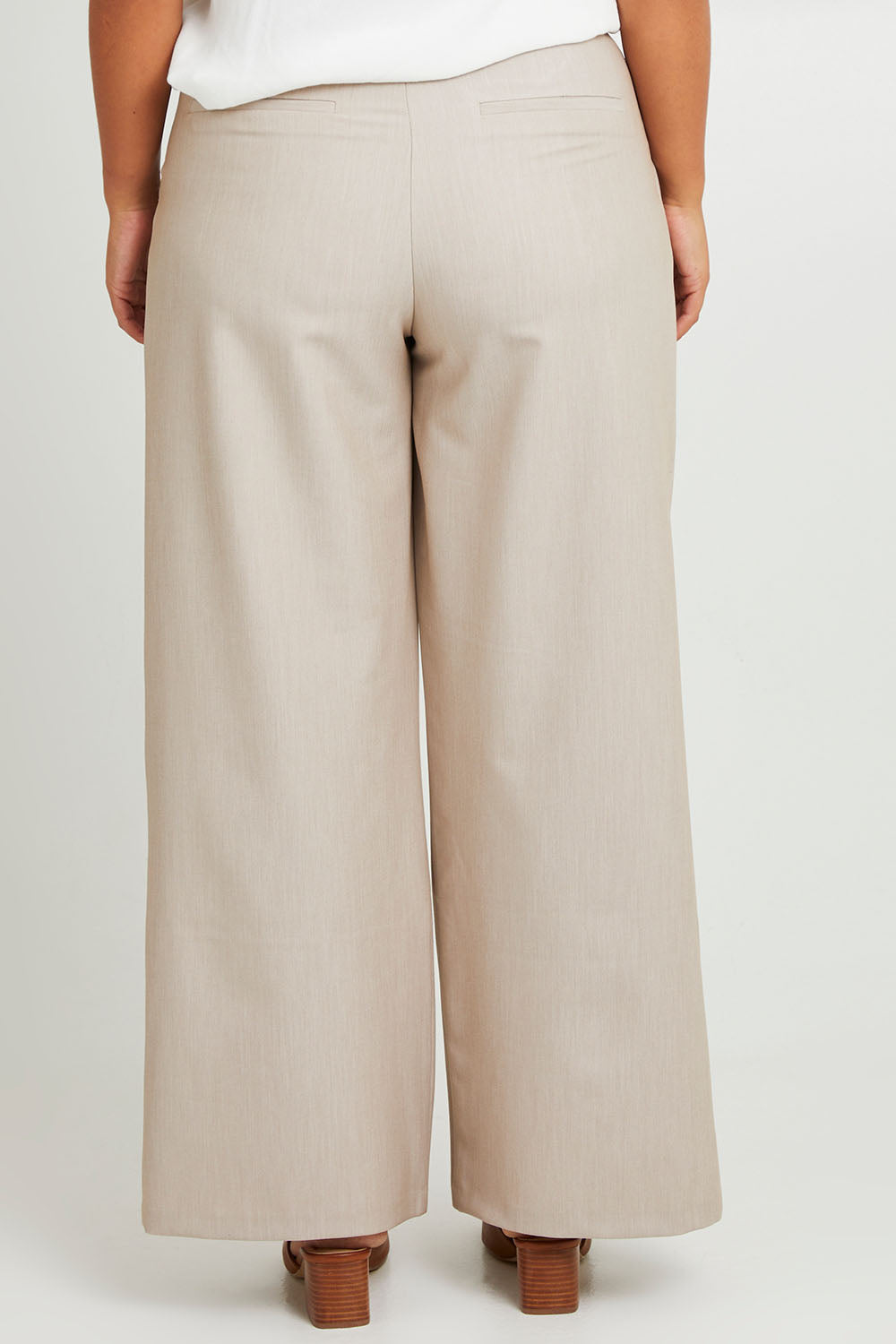 Model Monique wearing size 14 of the Elegant Persuasion Pants in colour Bone, from the back
