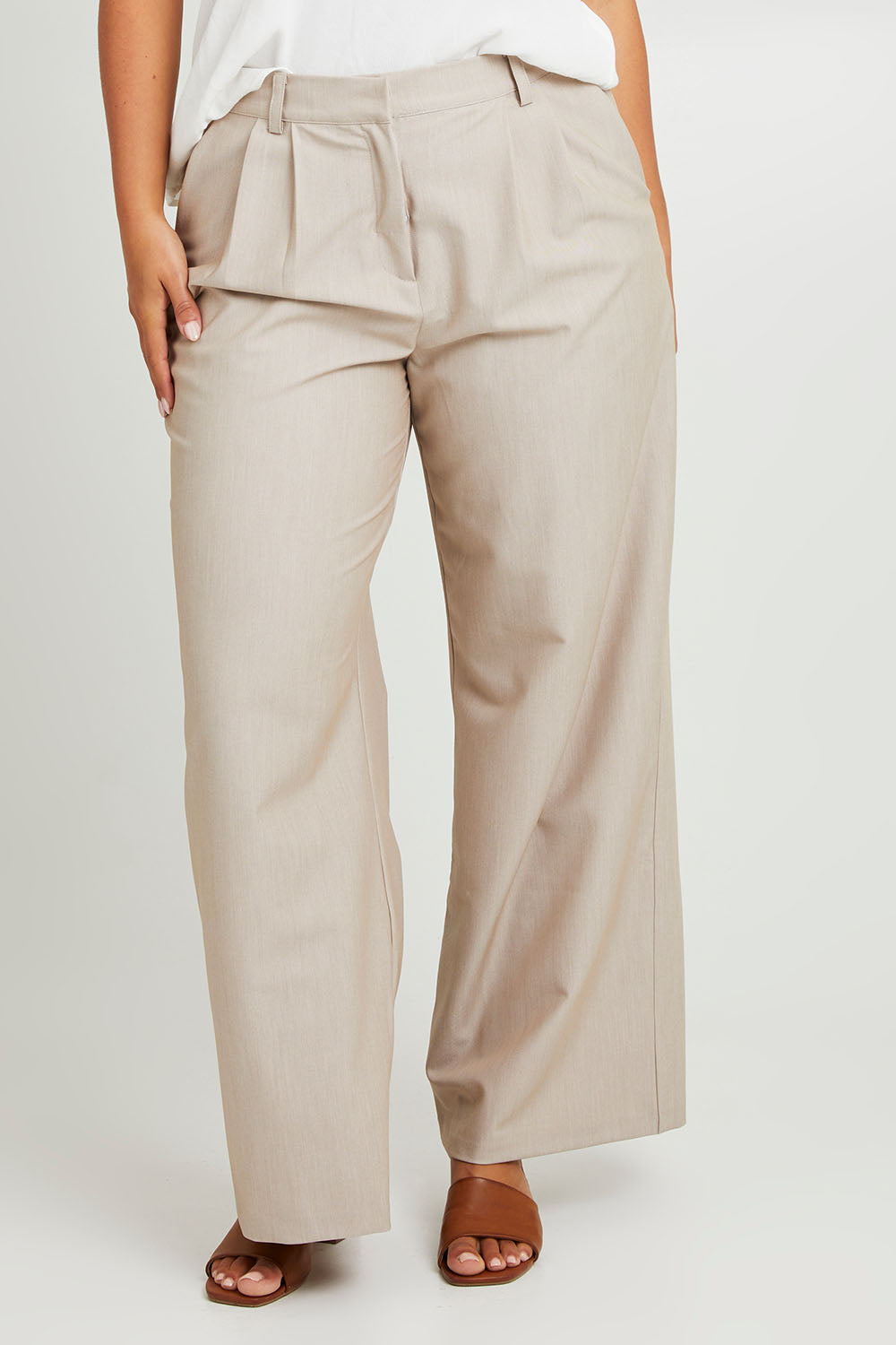 Model Monique wearing size 14 of the Elegant Persuasion Pants in colour Bone, from the front, cropped image