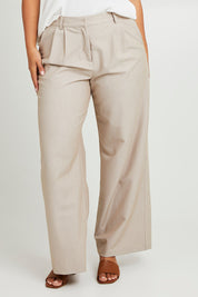 Model Monique wearing size 14 of the Elegant Persuasion Pants in colour Bone, from the front, cropped image