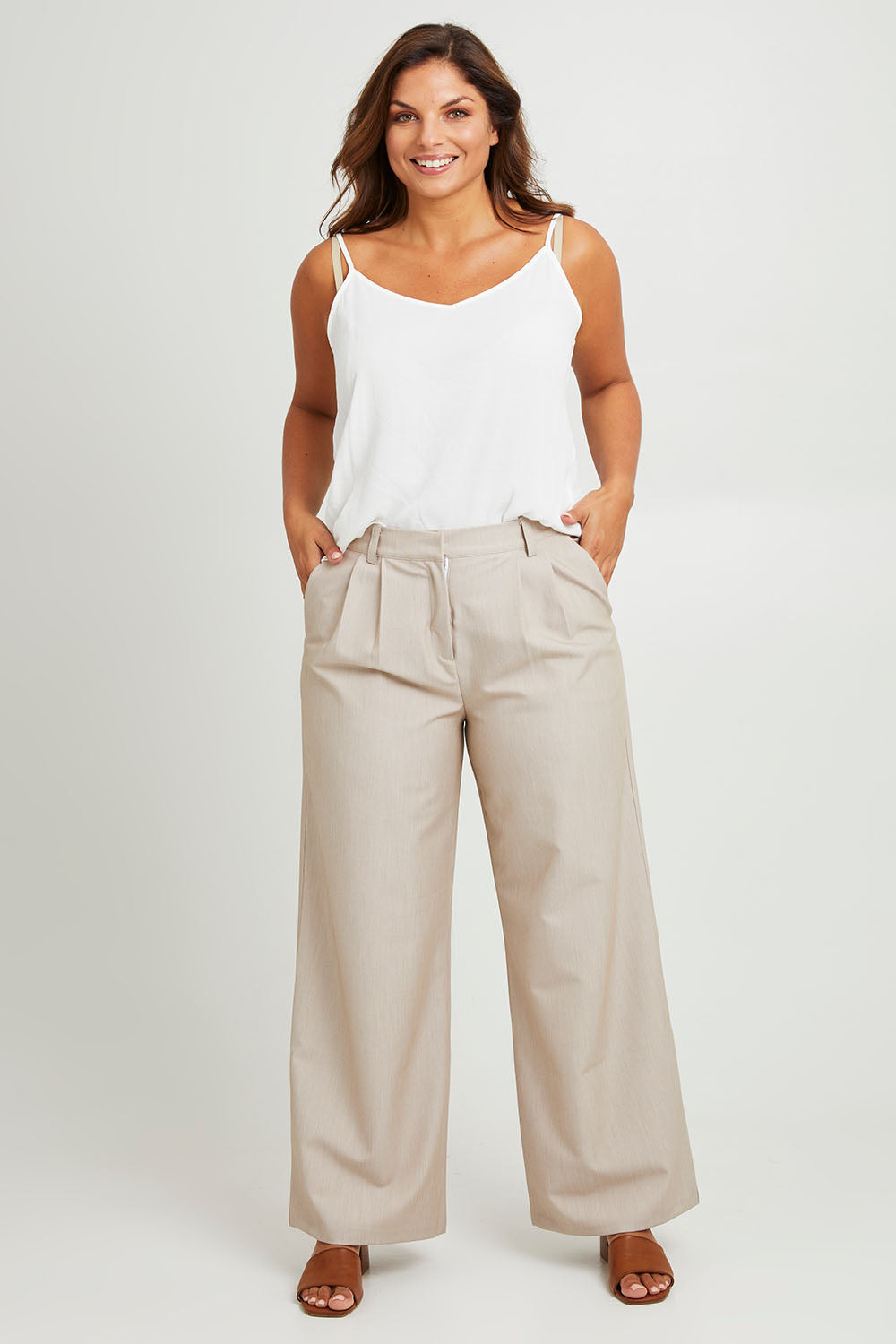 Model Monique wearing size 14 of the Elegant Persuasion Pants in colour Bone, from the front, showing the whole outfit