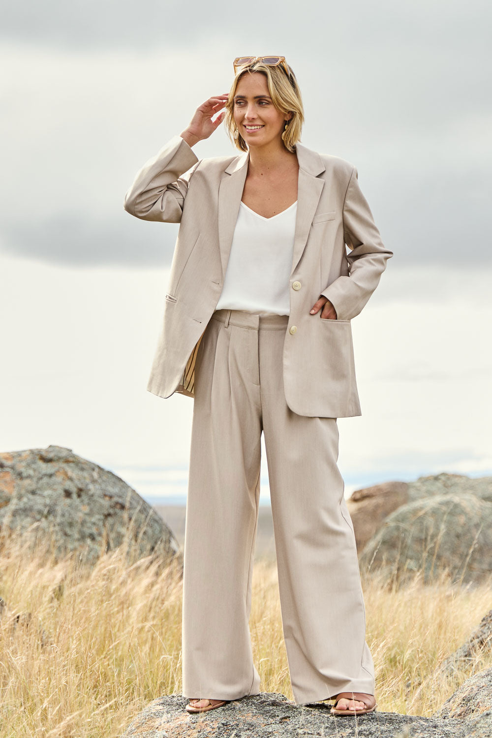 Model Tegan wearing size 10 of the Elegant Persuasion Pants in colour Bone, from the front, showing the whole outfit
