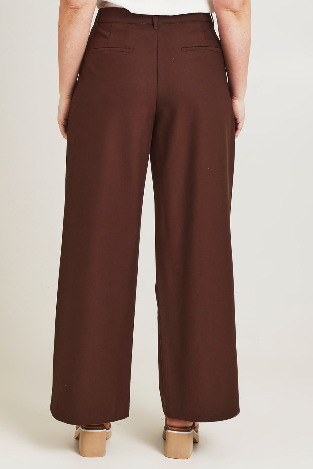 Model Jane wearing size 14 of the Elegant Persuasion Pants in colour Chocolate, from the back
