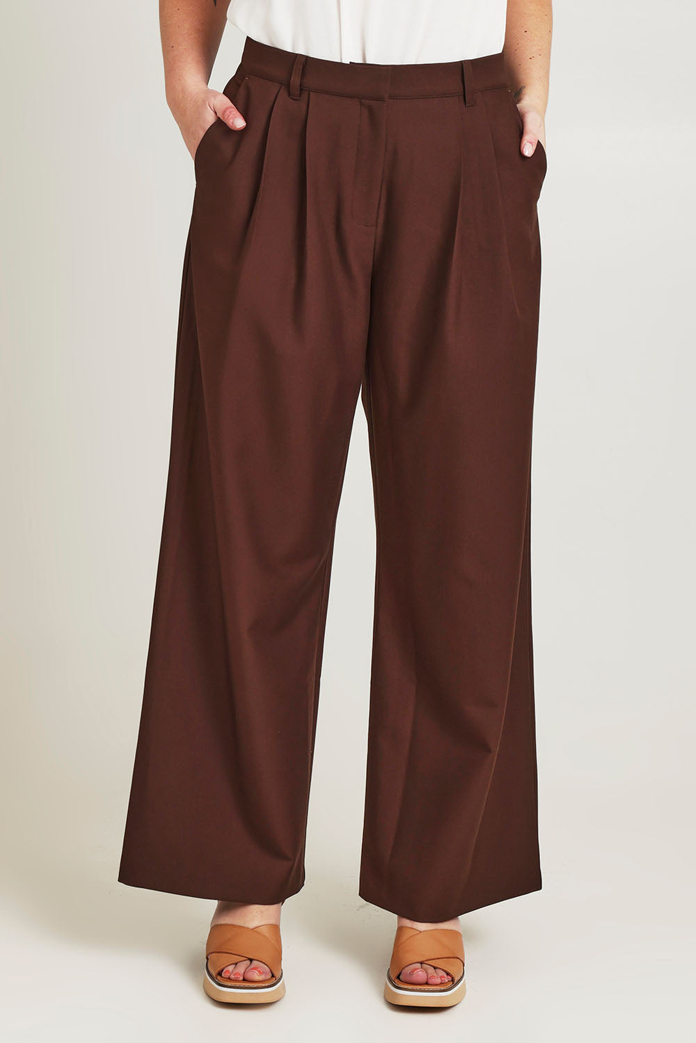 Model Jane wearing size 14 of the Elegant Persuasion Pants in colour Chocolate, from the front, cropped image