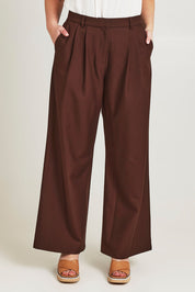Model Jane wearing size 14 of the Elegant Persuasion Pants in colour Chocolate, from the front, cropped image