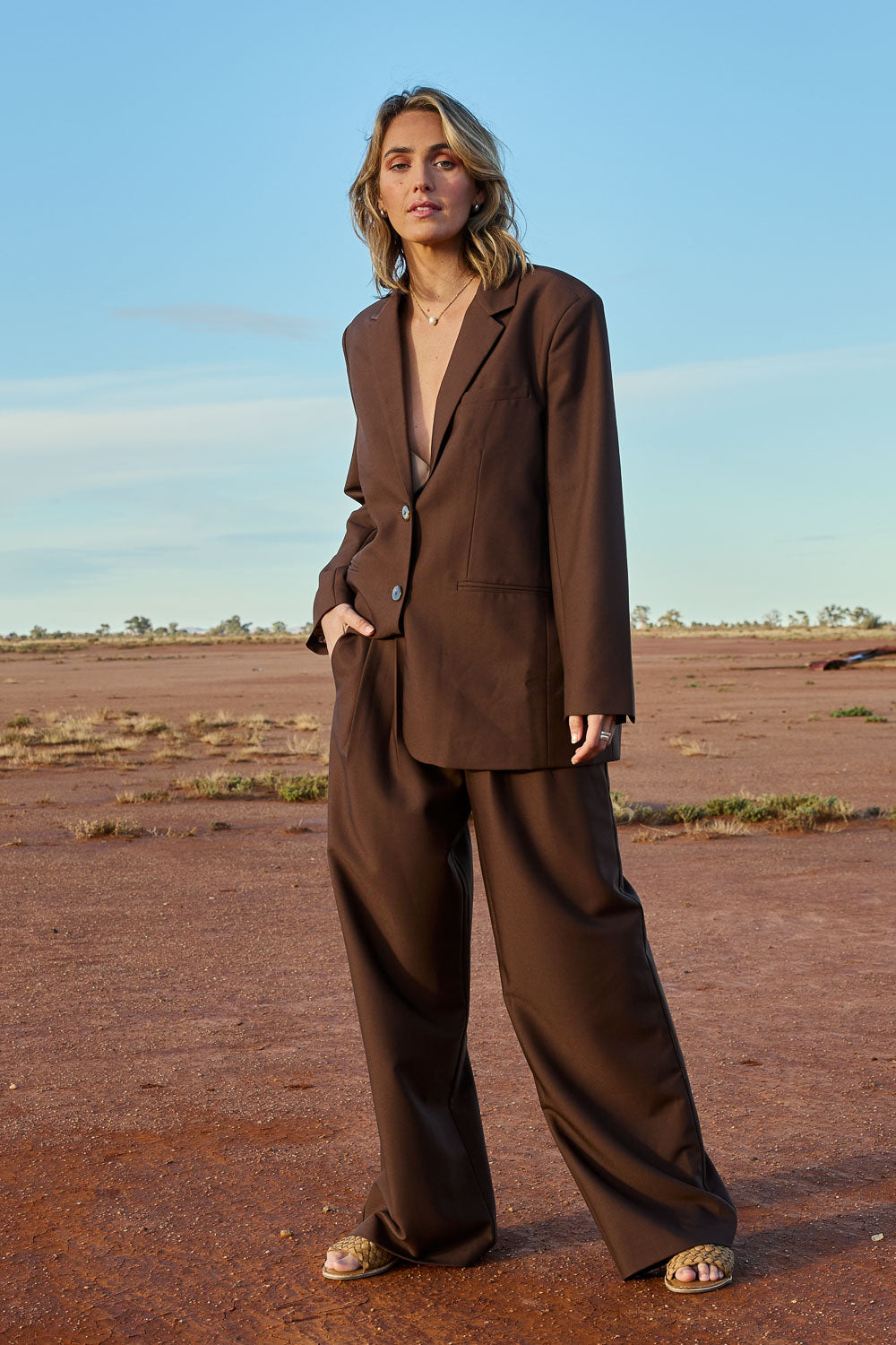 Model Tegan wearing size 10 of the Elegant Persuasion Pants in colour Chocolate, from the front, showing the whole outfit