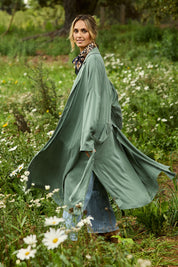 Model Tegan wearing size 10 of the Rendezvous Cupro Jacket in colour Ivy (Green), from the front, showing the whole outfit