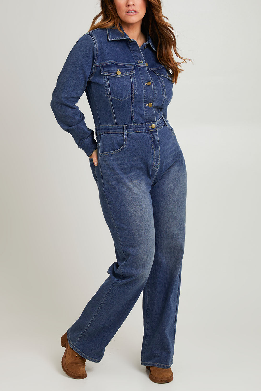 Model Laura wearing size 14 of the Denim Daze Jumpsuit in colour Darkdenim (Blue), from the front, cropped image