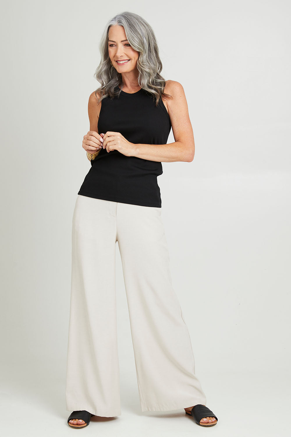 Model Luisa wearing size 10 of the Can Do Tank Top in colour Black (Black), from the front, showing the whole outfit