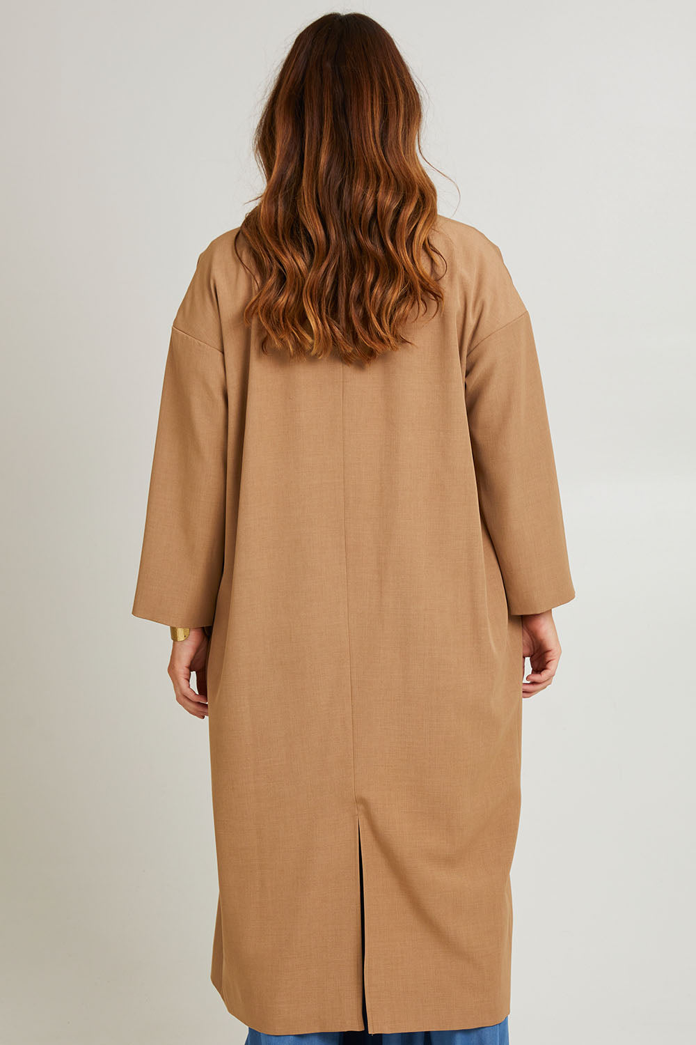 Model Laura wearing size 14 of the Suits Me Long Jacket in colour Earth, from the back