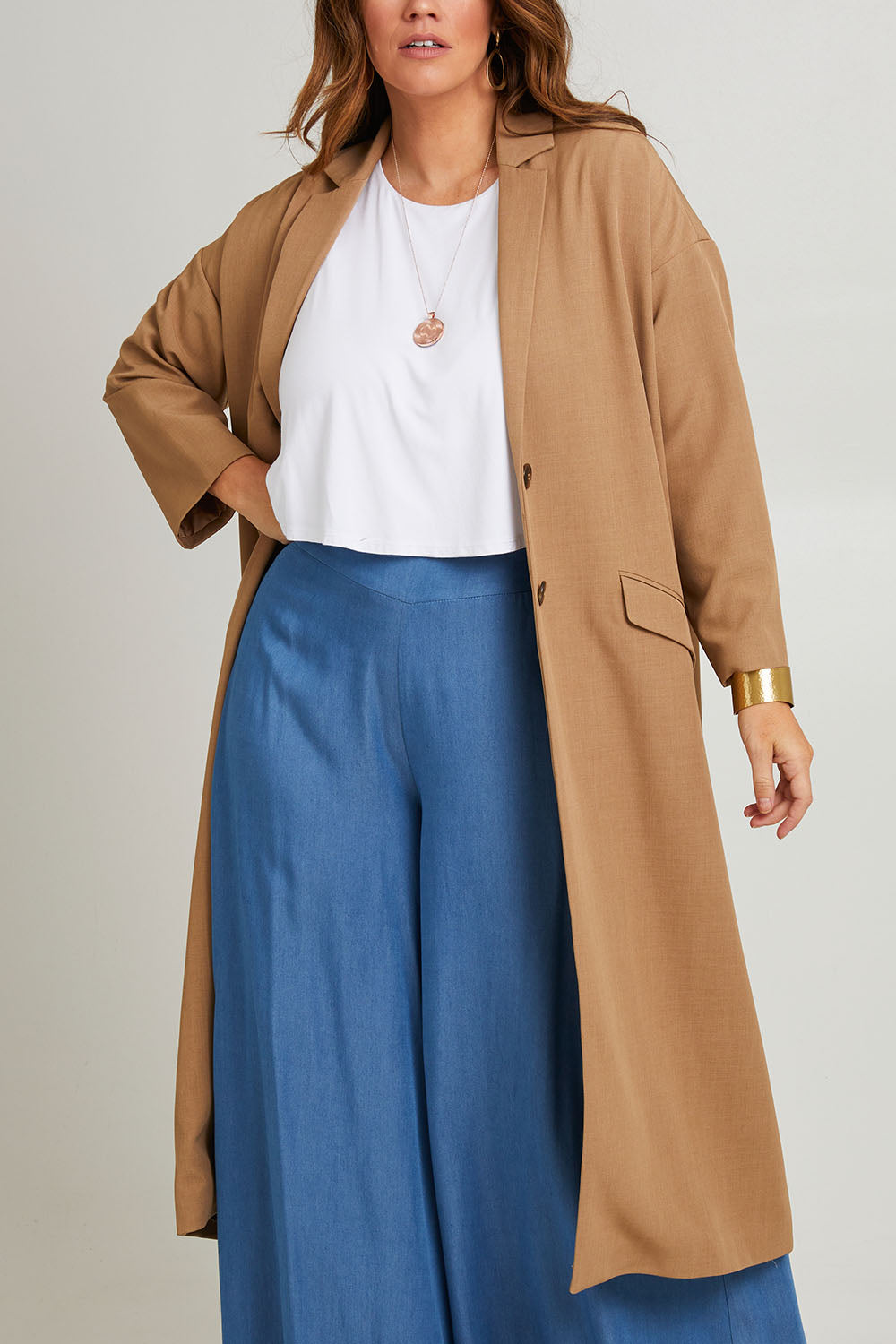 Model Laura wearing size 14 of the Suits Me Long Jacket in colour Earth, from the front, cropped image